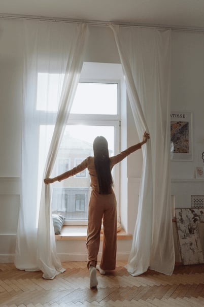 happy woman in window after trauma therapy, PTSD therapy, EMDR or counseling for teens in Frisco, Texas