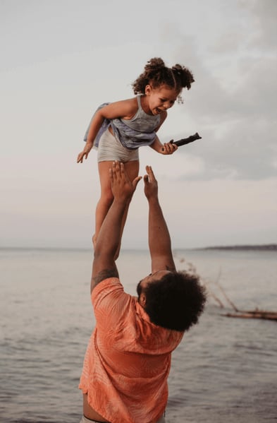 Happy parent after postpartum therapy, trauma therapy, PTSD therapy or counseling at Counseling and Nature Therapy Center in Frisco, Texas
