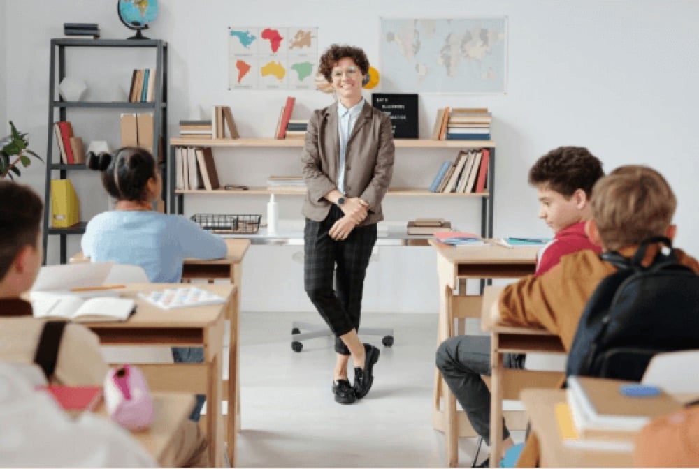 A classroom with empty desks and afternoon light through the windows