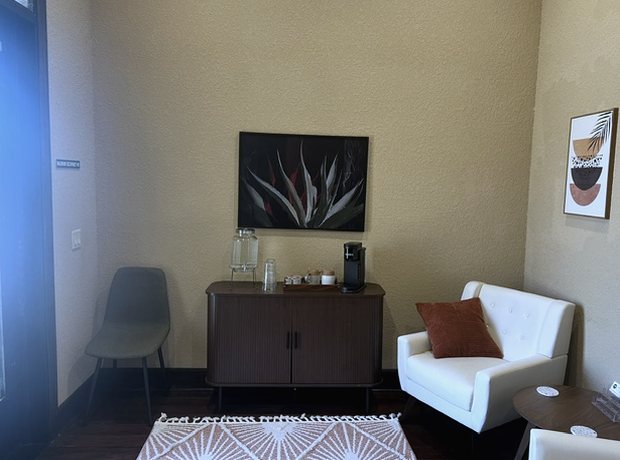 A quiet waiting area with two chairs and a side table